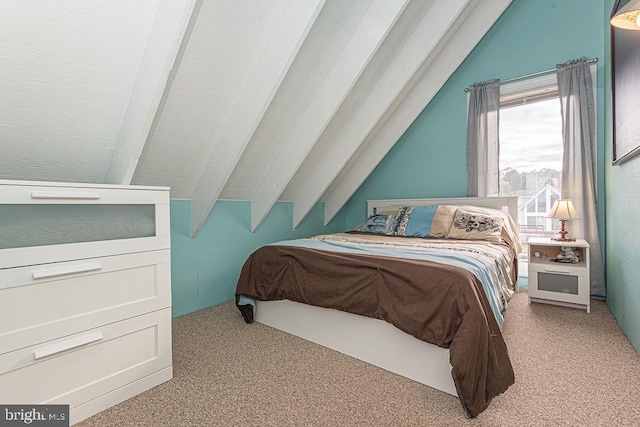 bedroom with lofted ceiling and carpet