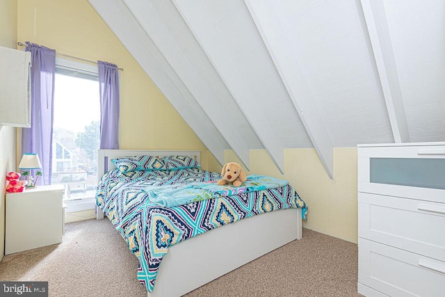 bedroom featuring vaulted ceiling and carpet