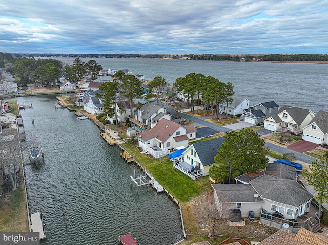 drone / aerial view with a water view and a residential view