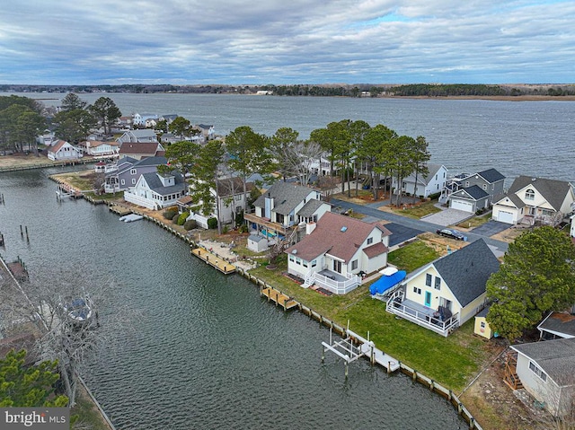 drone / aerial view with a water view and a residential view