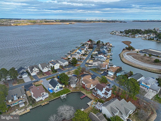 birds eye view of property with a water view and a residential view