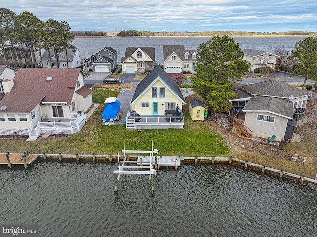 drone / aerial view featuring a water view and a residential view