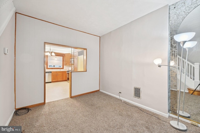 spare room with baseboards, visible vents, stairs, carpet flooring, and a sink