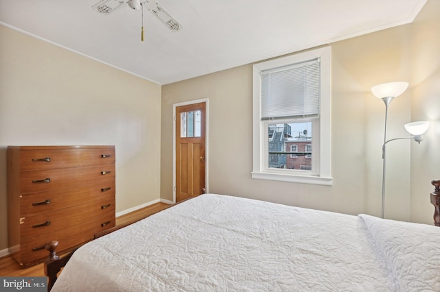 bedroom with baseboards and wood finished floors