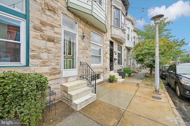 property entrance with stone siding