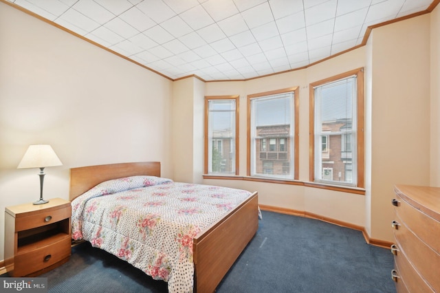 bedroom featuring baseboards, carpet, and crown molding