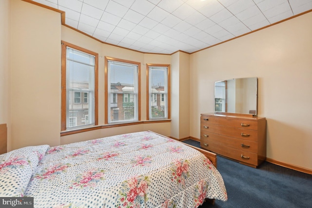 bedroom featuring ornamental molding, carpet, and baseboards