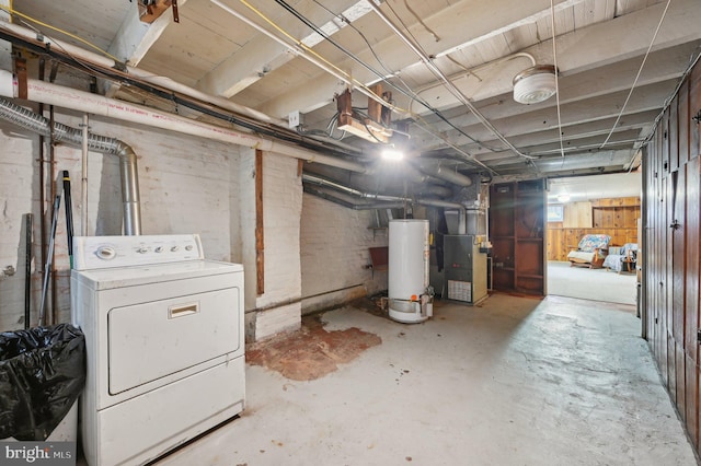 unfinished basement featuring washer / dryer, water heater, and heating unit