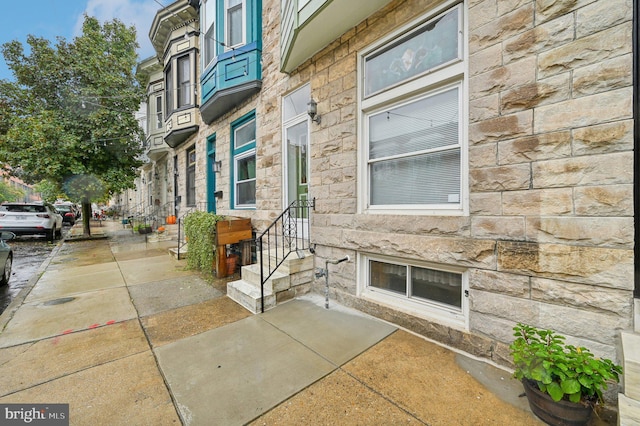 doorway to property with stone siding