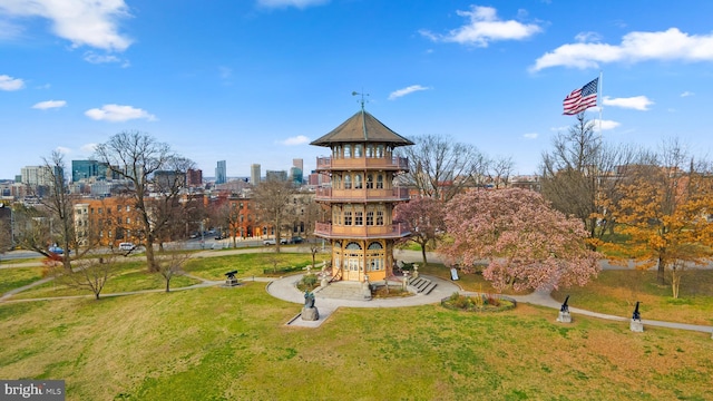 view of home's community with a city view and a lawn