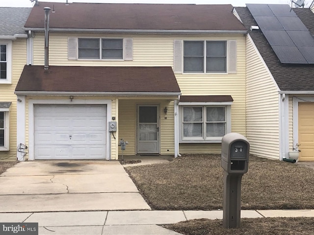 townhome / multi-family property with concrete driveway