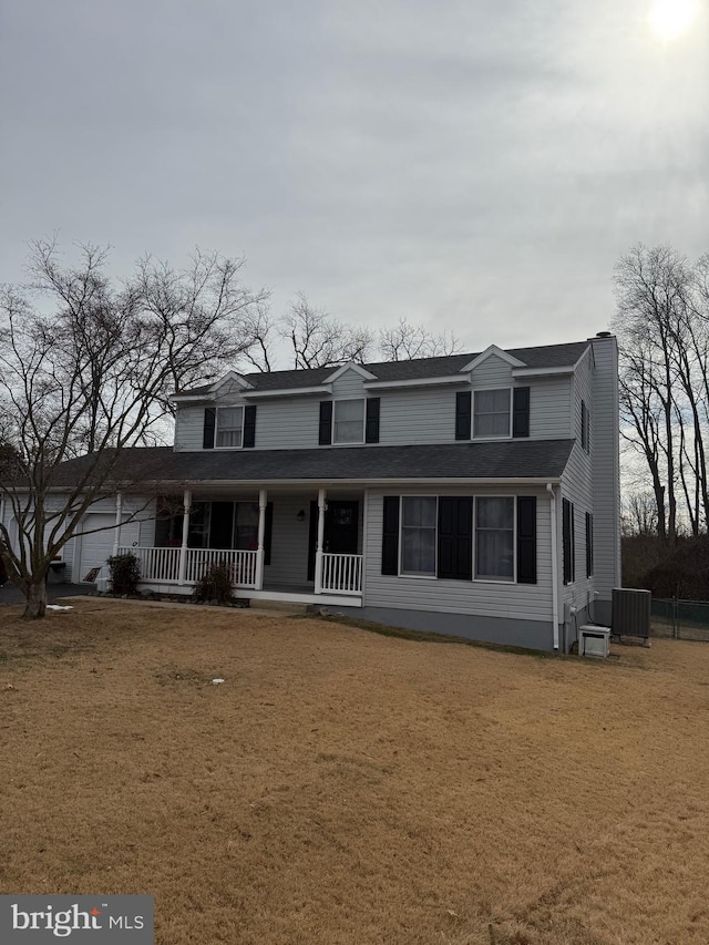 traditional home featuring a porch, central air condition unit, roof with shingles, a front lawn, and a chimney