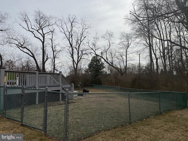 view of yard with a wooden deck and fence