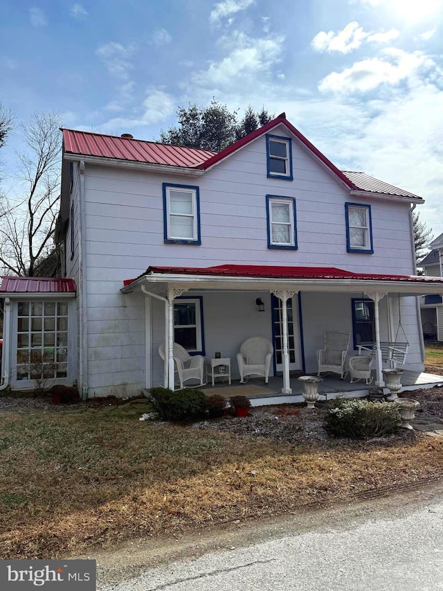 view of front of property with a porch and metal roof