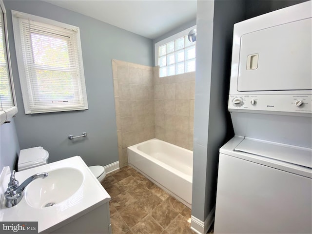 180 Bay Ave, Prince Frederick, MD 20678 - bathroom featuring toilet, vanity, baseboards, stacked washer / drying machine, and shower / bathing tub combination