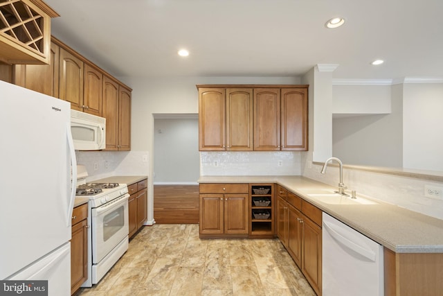 kitchen featuring recessed lighting, white appliances, light countertops, and a sink