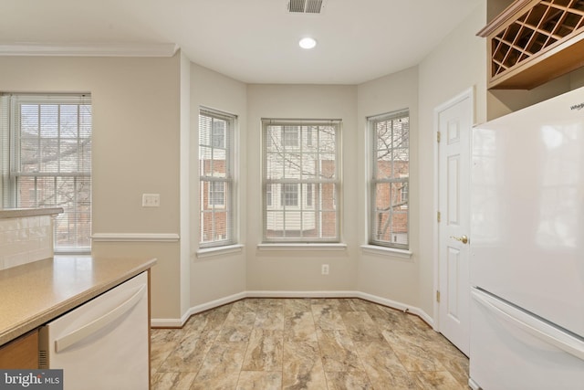 kitchen with white appliances, light countertops, light wood finished floors, and baseboards