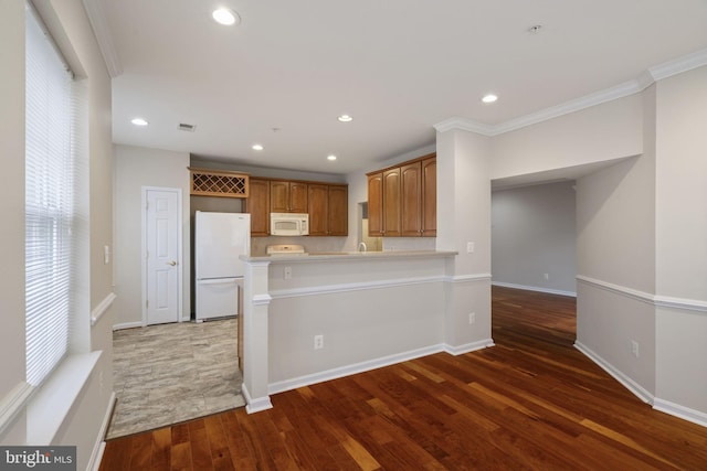 kitchen featuring dark wood-type flooring, recessed lighting, white appliances, and ornamental molding