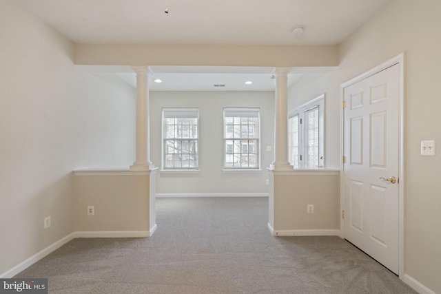 interior space with plenty of natural light, decorative columns, and baseboards