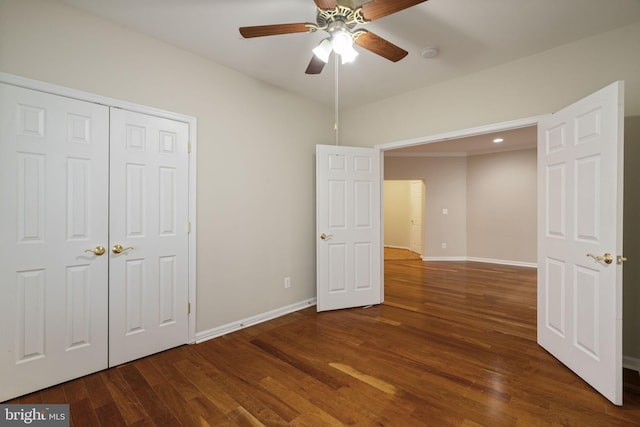 unfurnished bedroom with ceiling fan, a closet, baseboards, and wood finished floors