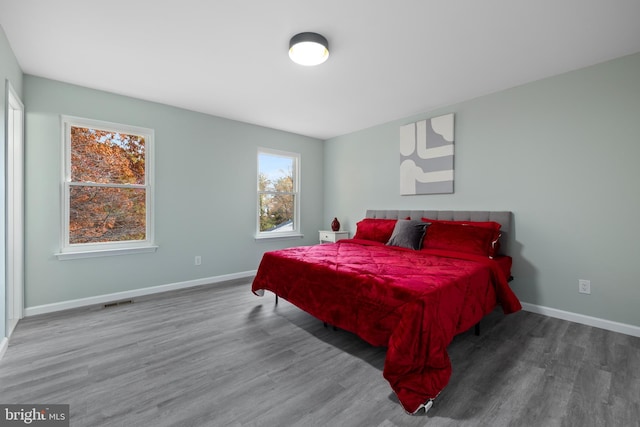 bedroom featuring baseboards and wood finished floors