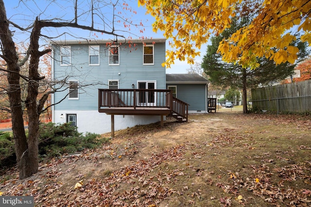 back of house with fence and a wooden deck