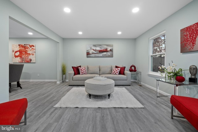 living area with light wood-type flooring, baseboards, and recessed lighting