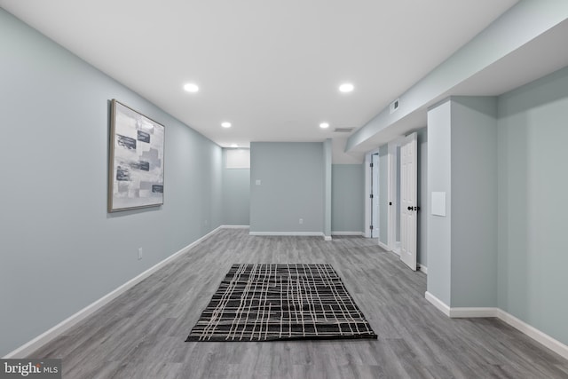 spare room featuring recessed lighting, wood finished floors, visible vents, and baseboards