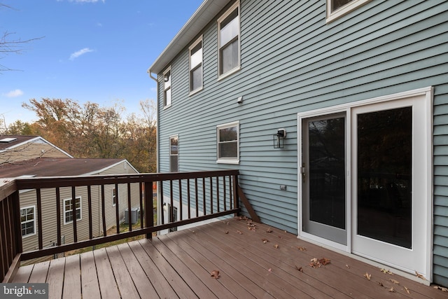 wooden deck featuring central air condition unit