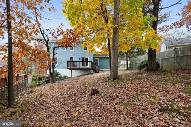 view of yard with a fenced backyard and a deck