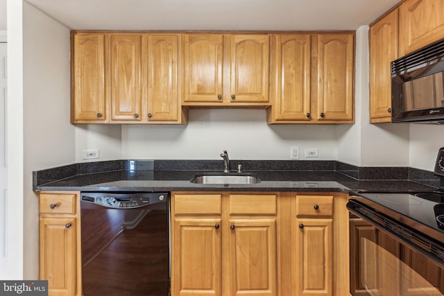 kitchen featuring dark stone countertops, a sink, and black appliances