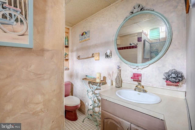 bathroom featuring tile patterned flooring, vanity, and toilet