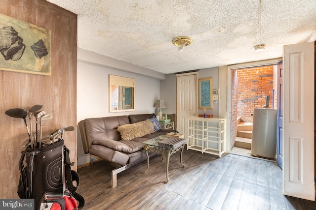 living room featuring a textured ceiling and wood finished floors