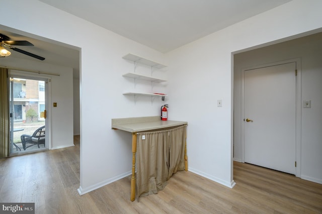 hall featuring light wood-style floors and baseboards