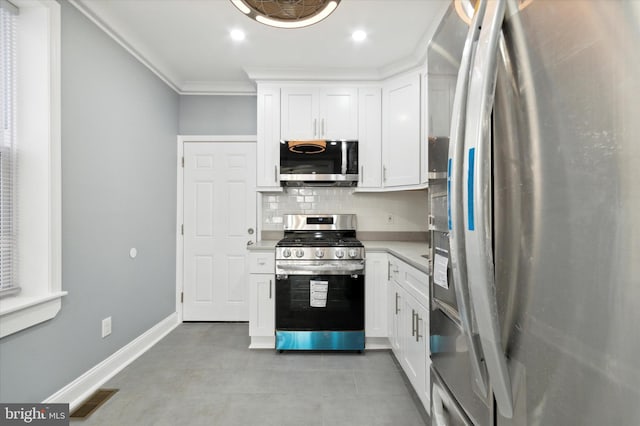 kitchen featuring appliances with stainless steel finishes, light countertops, visible vents, and white cabinetry