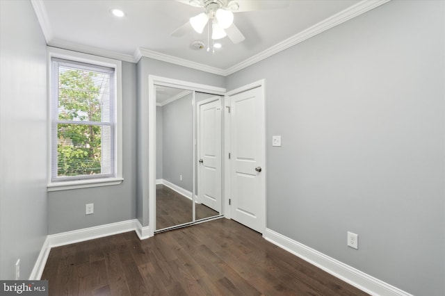 unfurnished bedroom featuring ornamental molding, dark wood finished floors, baseboards, and ceiling fan