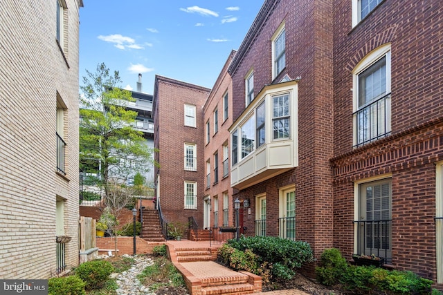 view of property with stairs and fence