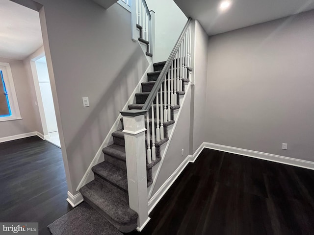 stairway featuring baseboards and wood finished floors