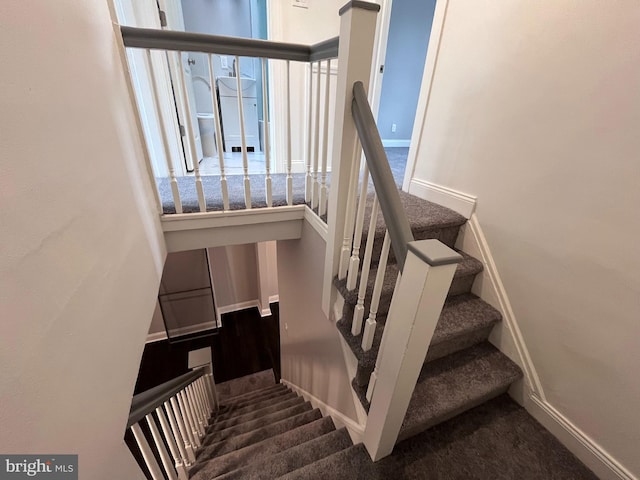 stairs featuring a wealth of natural light, carpet, and baseboards