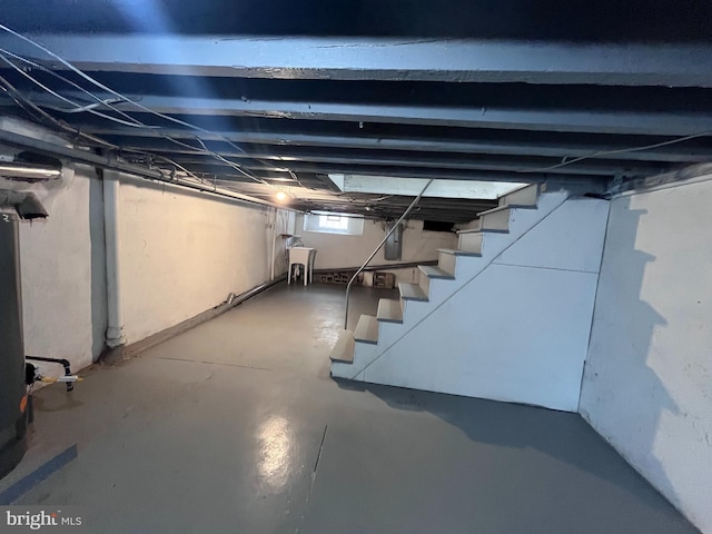 basement with stairs and electric panel