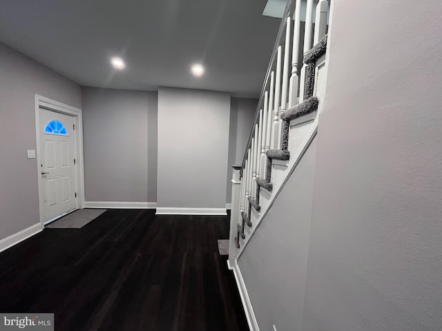 entrance foyer featuring dark wood-type flooring, stairway, recessed lighting, and baseboards