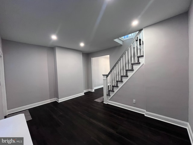 interior space featuring dark wood-style floors, baseboards, stairway, and recessed lighting