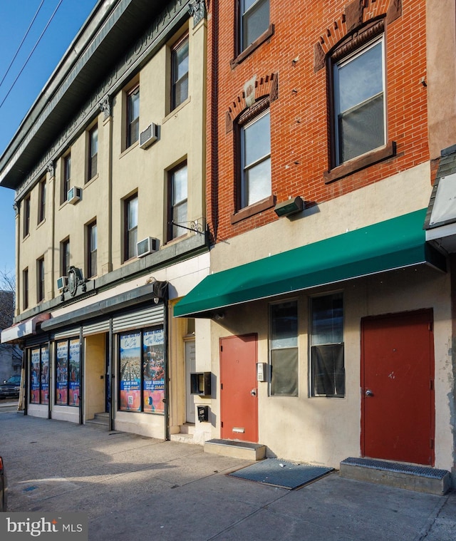 view of building exterior with a wall mounted AC