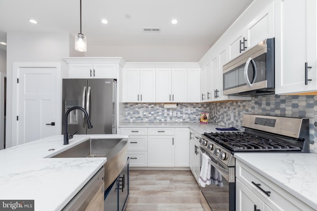 kitchen featuring white cabinetry, visible vents, and appliances with stainless steel finishes