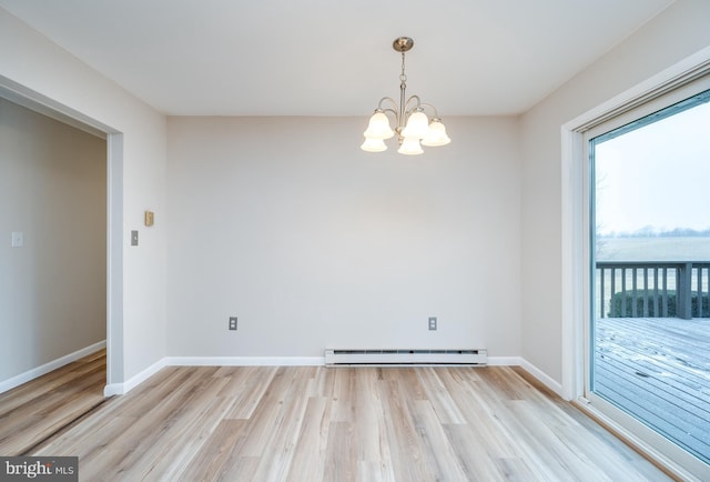 unfurnished dining area featuring a baseboard heating unit, light wood-type flooring, and baseboards