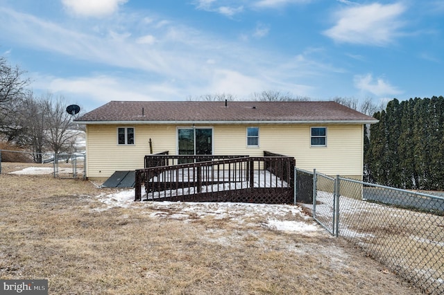 rear view of house with a deck and a fenced backyard