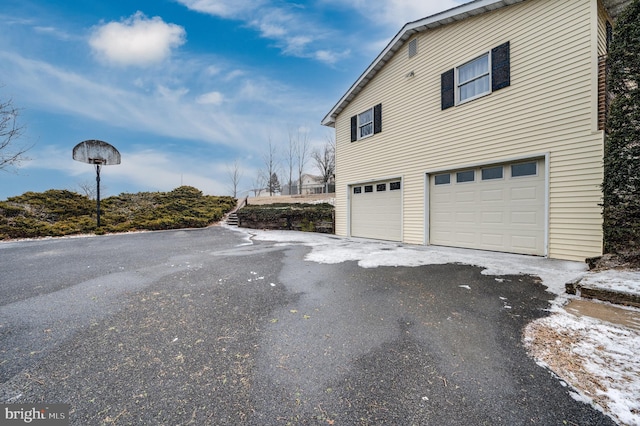 view of home's exterior featuring driveway and an attached garage