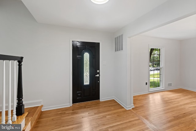 entrance foyer with baseboards, visible vents, and light wood finished floors