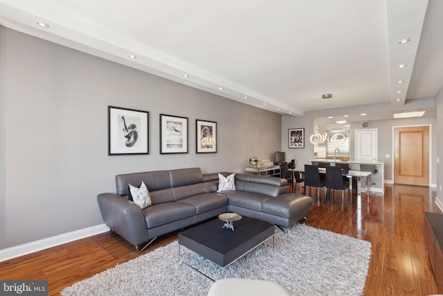 living room featuring recessed lighting, baseboards, and wood finished floors