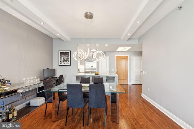 dining area with recessed lighting, wood finished floors, beam ceiling, and baseboards